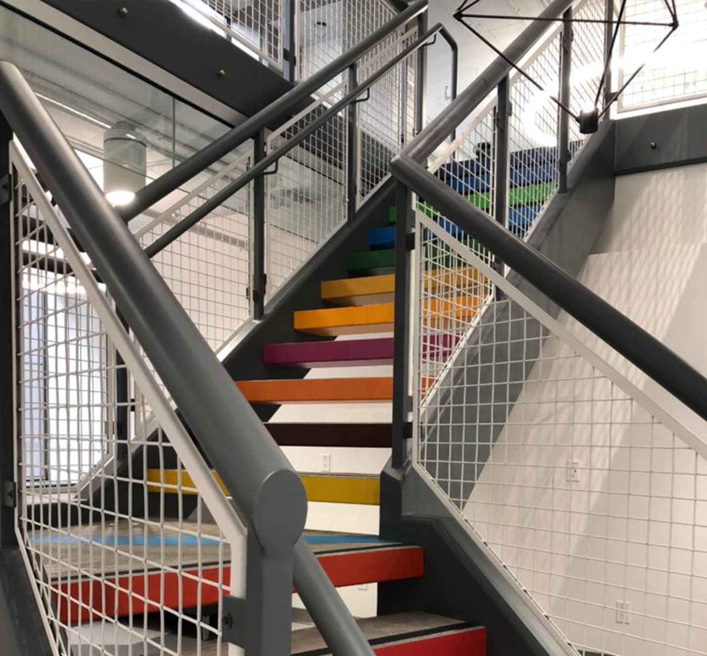 A multi-coloured staircase leading up to Impact Hub Ottawa