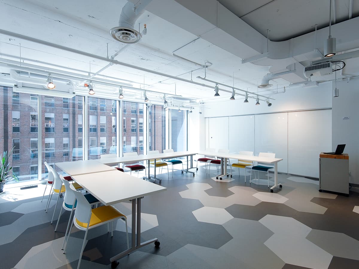 A meeting room with hexagonal floors, and bright and big windows